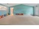 Open living area features decorative pillows, view into the kitchen and doorway, and neutral carpet at 8430 Sw 90Th Ln # A, Ocala, FL 34481