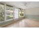 Bright sunroom with tile floors features large windows offering peaceful outdoor views at 8430 Sw 90Th Ln # A, Ocala, FL 34481