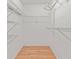 Walk-in closet with ventilated shelving, laminate wood flooring, and ample storage space at 8430 Sw 90Th Ln # A, Ocala, FL 34481