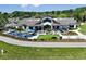 Aerial view of a stunning clubhouse with a spacious outdoor patio and manicured landscaping at 8843 Sw 57Th Place Rd, Ocala, FL 34481