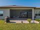 Exterior shot of home featuring screened in patio with table and grill in the backyard at 8843 Sw 57Th Place Rd, Ocala, FL 34481