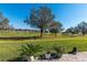 View from the patio showcasing the backyard and golf course view beyond the house at 8843 Sw 57Th Place Rd, Ocala, FL 34481