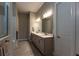 Bathroom featuring a double sink vanity, stone countertops, and modern lighting at 8843 Sw 57Th Place Rd, Ocala, FL 34481