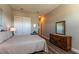 Bedroom featuring wood floors, dresser, and closet at 8843 Sw 57Th Place Rd, Ocala, FL 34481