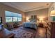Comfortable bedroom features a tray ceiling, rug, and view of the outdoors at 8843 Sw 57Th Place Rd, Ocala, FL 34481