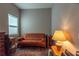 Bedroom with wood floor, brown futon, and natural light at 8843 Sw 57Th Place Rd, Ocala, FL 34481