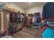 Walk-in closet with metal racks for clothes, shoes, and storage bins, showcasing ample storage space at 8843 Sw 57Th Place Rd, Ocala, FL 34481