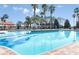 Large community pool with palm trees, lounge chairs, and ample space for relaxation and recreation at 8843 Sw 57Th Place Rd, Ocala, FL 34481