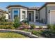Inviting home showcasing lovely landscaping and a cozy front patio with chairs at 8843 Sw 57Th Place Rd, Ocala, FL 34481