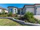Inviting home showcasing lovely landscaping and a cozy front patio with chairs at 8843 Sw 57Th Place Rd, Ocala, FL 34481
