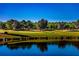 Scenic view of the Stone Creek golf course featuring a pond and trees at 8843 Sw 57Th Place Rd, Ocala, FL 34481