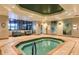 Relaxing indoor hot tub area with tile surround, seating, and attractive decor at 8843 Sw 57Th Place Rd, Ocala, FL 34481