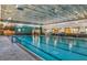 Bright, indoor pool with clean tile, clear water, and ample lighting at 8843 Sw 57Th Place Rd, Ocala, FL 34481