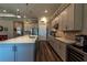 Open kitchen with gray cabinets, hardwood floors, and stainless steel appliances at 8843 Sw 57Th Place Rd, Ocala, FL 34481