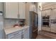 Modern kitchen featuring gray cabinets, stainless steel appliances, and quartz countertops at 8843 Sw 57Th Place Rd, Ocala, FL 34481