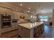 Well-lit kitchen with large island, wood floors and bar stool seating at 8843 Sw 57Th Place Rd, Ocala, FL 34481