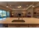 Bright kitchen island with sink and overhead lighting at 8843 Sw 57Th Place Rd, Ocala, FL 34481