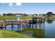 Scenic lake view with a charming gazebo and fountain, surrounded by well-maintained landscaping at 8843 Sw 57Th Place Rd, Ocala, FL 34481