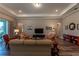Spacious living room with hardwood floors, neutral walls, and a large TV above a cabinet at 8843 Sw 57Th Place Rd, Ocala, FL 34481
