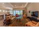 Open living space featuring hardwood floors, comfortable seating, and a sliding glass door at 8843 Sw 57Th Place Rd, Ocala, FL 34481