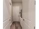 Functional mud room with built-in storage, exterior door, and wood-look flooring, blending practicality at 8843 Sw 57Th Place Rd, Ocala, FL 34481
