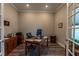 This is a well-lit home office featuring hardwood floors, a wooden desk, and ample storage space at 8843 Sw 57Th Place Rd, Ocala, FL 34481