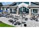 Expansive outdoor patio with comfortable seating and a modern fire pit, ideal for gatherings at 8843 Sw 57Th Place Rd, Ocala, FL 34481