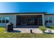 View of the screened in patio and grill with table set in the backyard at 8843 Sw 57Th Place Rd, Ocala, FL 34481