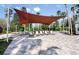Outdoor lounge area featuring comfortable seating under a large shade sail, perfect for relaxation at 8843 Sw 57Th Place Rd, Ocala, FL 34481