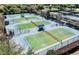 Aerial view of well-maintained tennis courts with covered resting areas at 8843 Sw 57Th Place Rd, Ocala, FL 34481