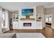 Bright living room with a decorative fireplace, built-in shelving, and ample natural light from large windows at 1 Hemlock Terrace Trak, Ocala, FL 34472