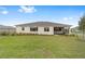 Lush green backyard with a cozy screened lanai for outdoor enjoyment at 10314 Sw 96Th Loop, Ocala, FL 34481