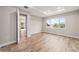 Airy bedroom featuring wood floors, a large window with a view, and neutral paint at 10314 Sw 96Th Loop, Ocala, FL 34481