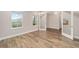 Sunlit bedroom with wood-look flooring, large windows, and neutral paint, creating a serene and inviting atmosphere at 10314 Sw 96Th Loop, Ocala, FL 34481