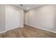 Cozy bedroom with wood-look flooring, a closet with sliding doors, and neutral paint, offering a comfortable living space at 10314 Sw 96Th Loop, Ocala, FL 34481