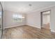 Light filled dining area with wood floors, window, and view of the entry way at 10314 Sw 96Th Loop, Ocala, FL 34481