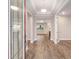Inviting entryway featuring wood-look flooring and a decorative glass front door, creating a warm and stylish welcome at 10314 Sw 96Th Loop, Ocala, FL 34481