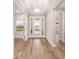 Bright entryway with beautiful wood-look flooring, glass front door, and neutral paint, creating a welcoming ambiance at 10314 Sw 96Th Loop, Ocala, FL 34481