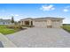 Charming single-story home featuring a three-car garage and a patterned brick driveway at 10314 Sw 96Th Loop, Ocala, FL 34481