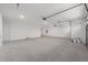 Large garage with bright lights, concrete floors, and garage door at 10314 Sw 96Th Loop, Ocala, FL 34481