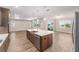 Kitchen featuring a large island, stainless steel appliances, and adjacent living area at 10314 Sw 96Th Loop, Ocala, FL 34481