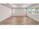 Open living area highlighting wood-look flooring and large windows, creating a bright and inviting space at 10314 Sw 96Th Loop, Ocala, FL 34481