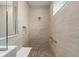 Shower features tile walls, a built-in niche, a small seat, and pebble flooring at 10314 Sw 96Th Loop, Ocala, FL 34481