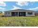 Expansive backyard featuring lush green grass and an inviting screened-in lanai, great for entertaining at 10557 Sw 98Th Ln, Ocala, FL 34481