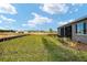 Spacious green backyard with landscaping and screened lanai that overlooks a green space at 10557 Sw 98Th Ln, Ocala, FL 34481