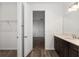 Bright bathroom view to the closet, the sink vanity and hardwood floors at 10557 Sw 98Th Ln, Ocala, FL 34481