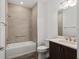 Well lit bathroom with tile surround, shower, and dark wood vanity with a white countertop at 10557 Sw 98Th Ln, Ocala, FL 34481