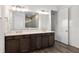 Bathroom with double sinks, cabinets, large mirror and shower at 10557 Sw 98Th Ln, Ocala, FL 34481