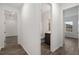 Hallway view of bathroom complete with vanity and tile enclosed shower at 10557 Sw 98Th Ln, Ocala, FL 34481