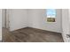 A light filled bedroom with hard wood flooring and a window with a view of the outdoors at 10557 Sw 98Th Ln, Ocala, FL 34481